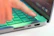 Close-up of hands clicking a vibrant call-to-action button on a laptop screen.