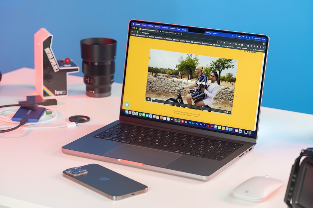 a laptop computer sitting on top of a white desk