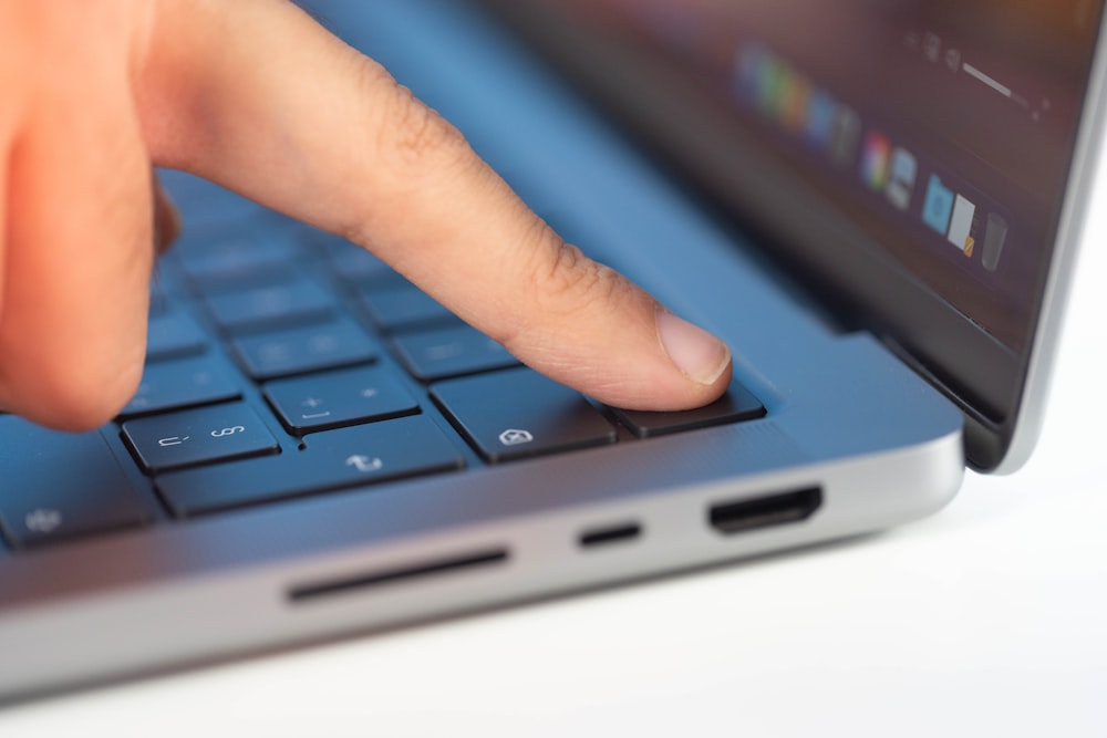 a close up of a person typing on a laptop