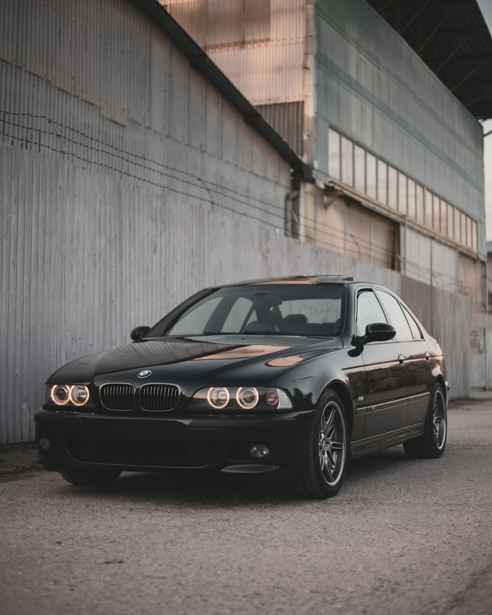 a black car parked in front of a building