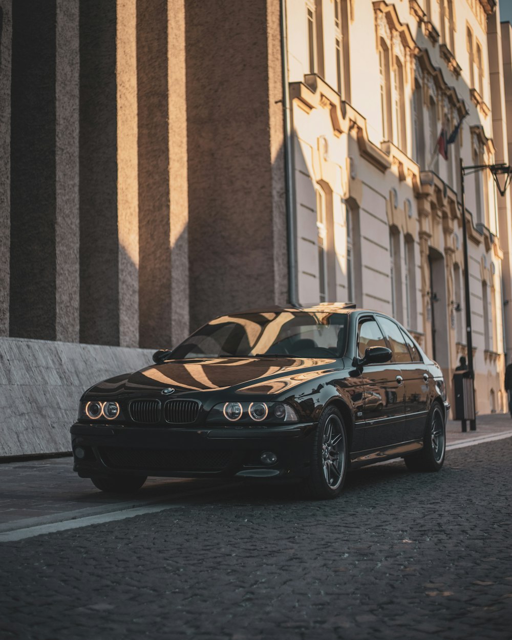 a black car parked on the side of a street