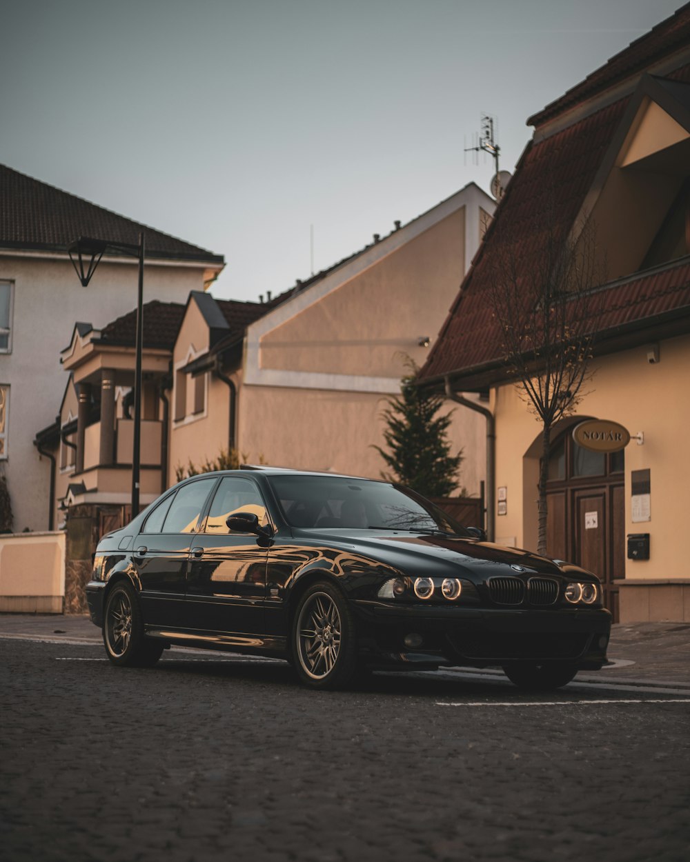 a black car parked in front of a building