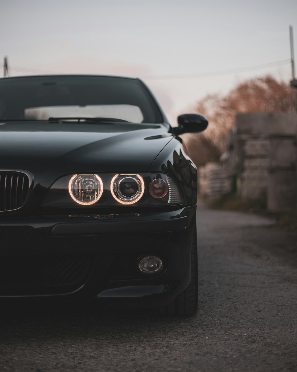 a black car parked on the side of a road