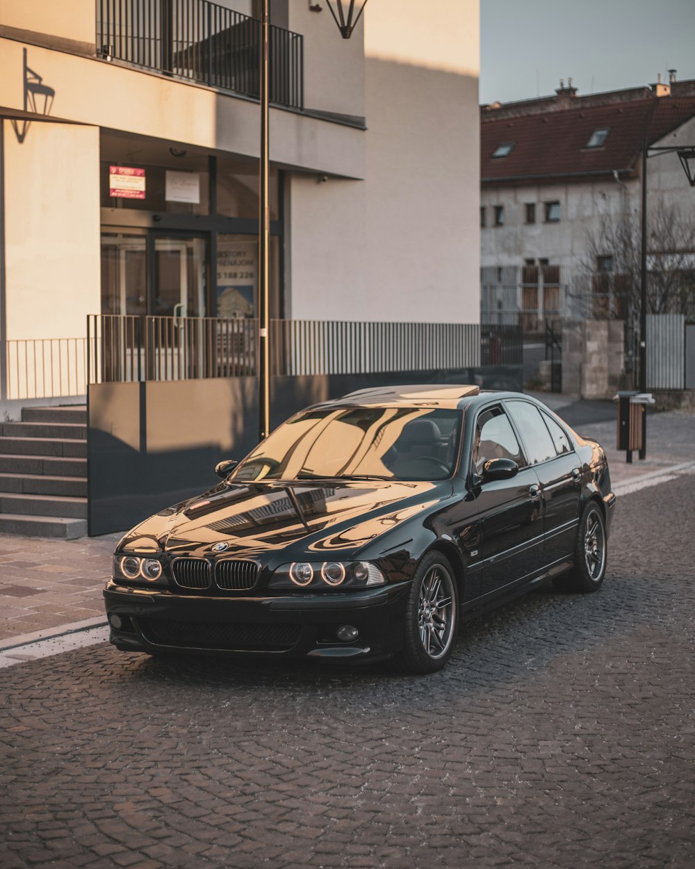 a black car parked in front of a building