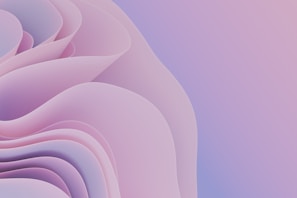 A soft, abstract design featuring layers of pastel-colored, flowing shapes resembling petals or waves. The image is dominated by hues of pink and purple with a gradual transition to a light blue.