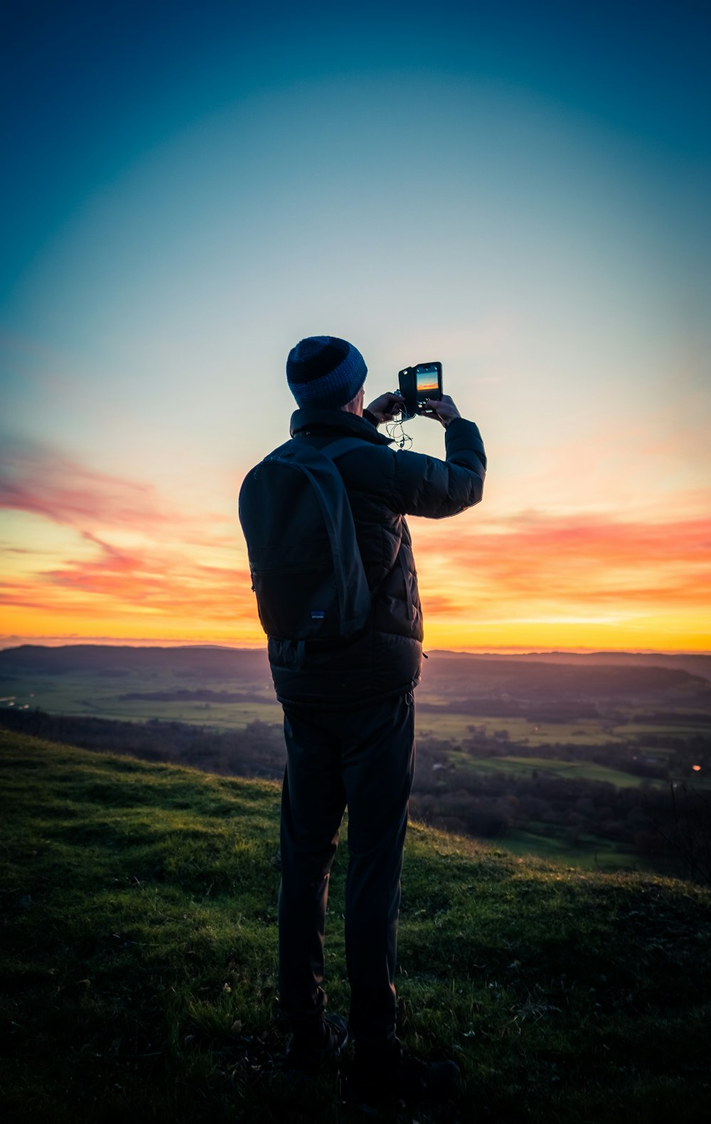 a man standing on top of a lush green field