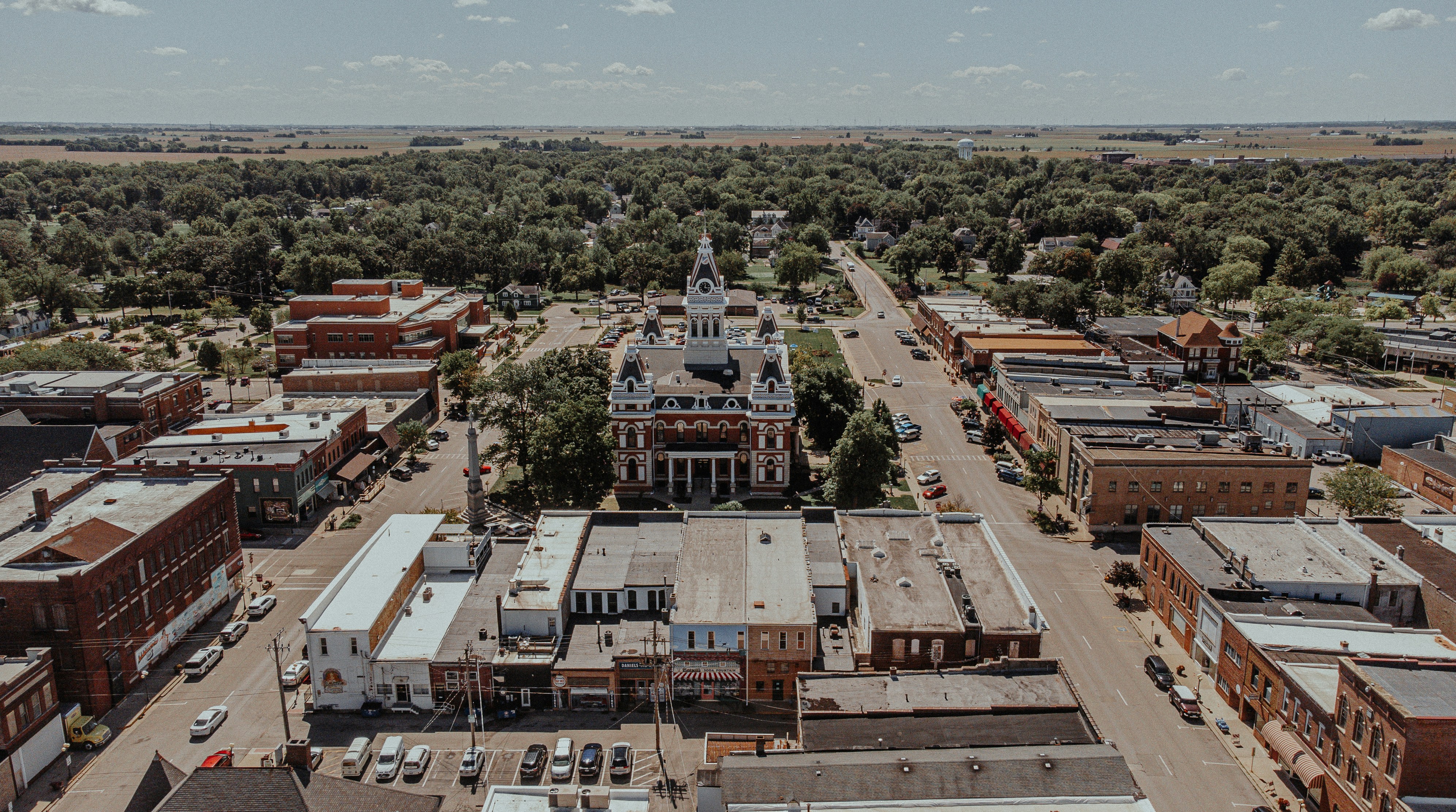 an aerial view of a small town with lots of buildings, 