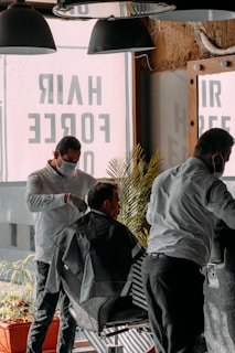 a man getting his hair cut at a barber shop