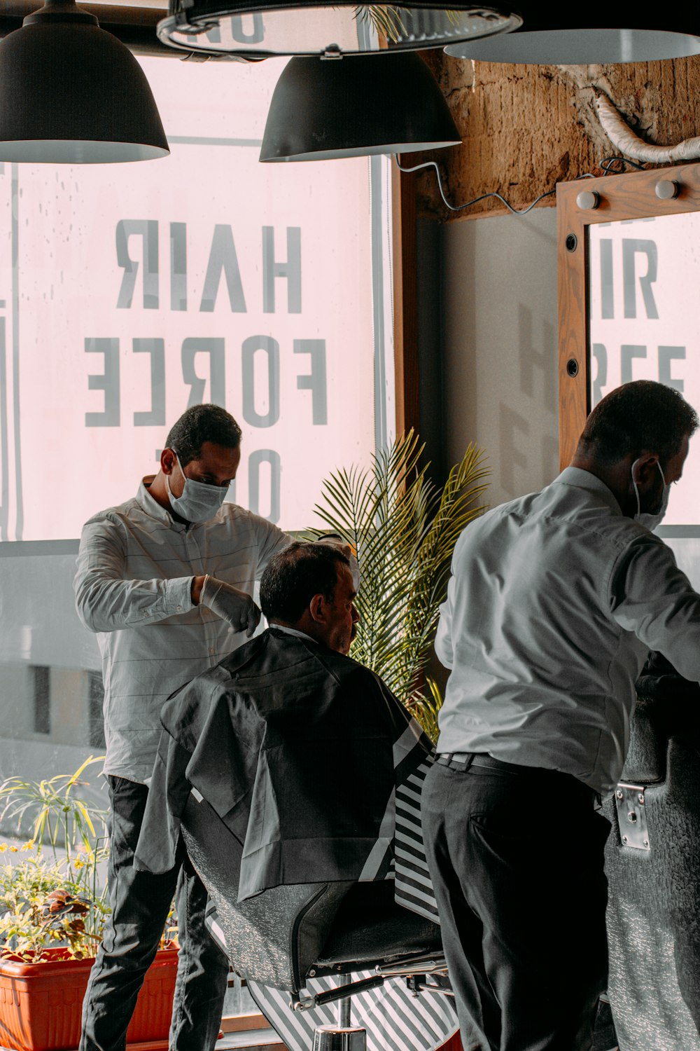 a man getting his hair cut at a barber shop