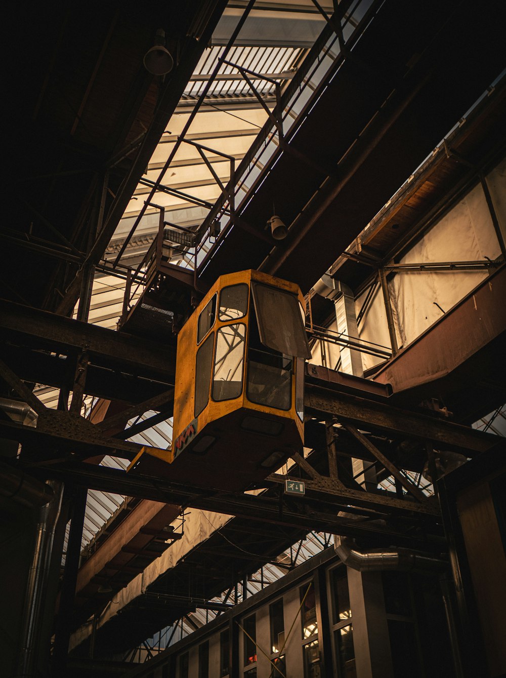 a yellow train sitting inside of a train station