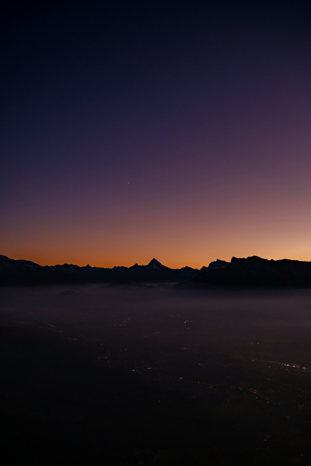 a view of a mountain range at sunset