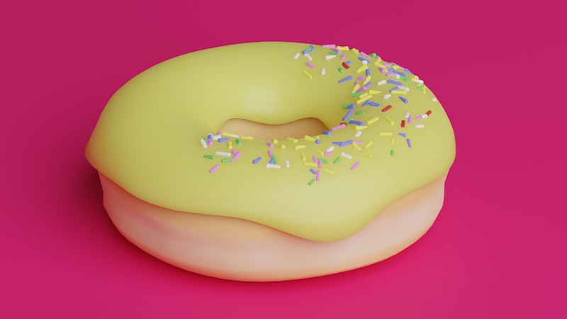 a yellow donut with sprinkles on a pink background