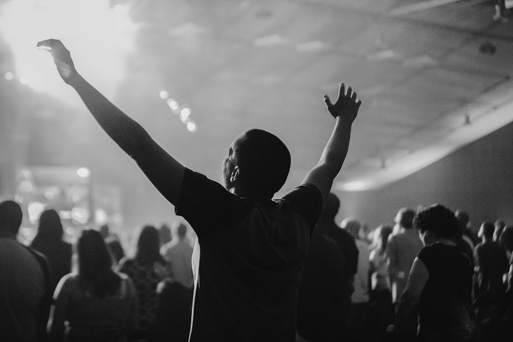 a man standing in front of a crowd at a concert