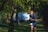 A person jogging in a park wearing wireless earbuds, focused and energized.