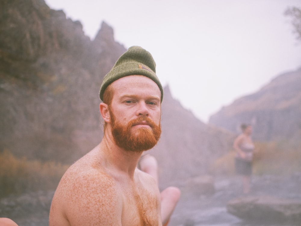 a man with a red beard and a green hat