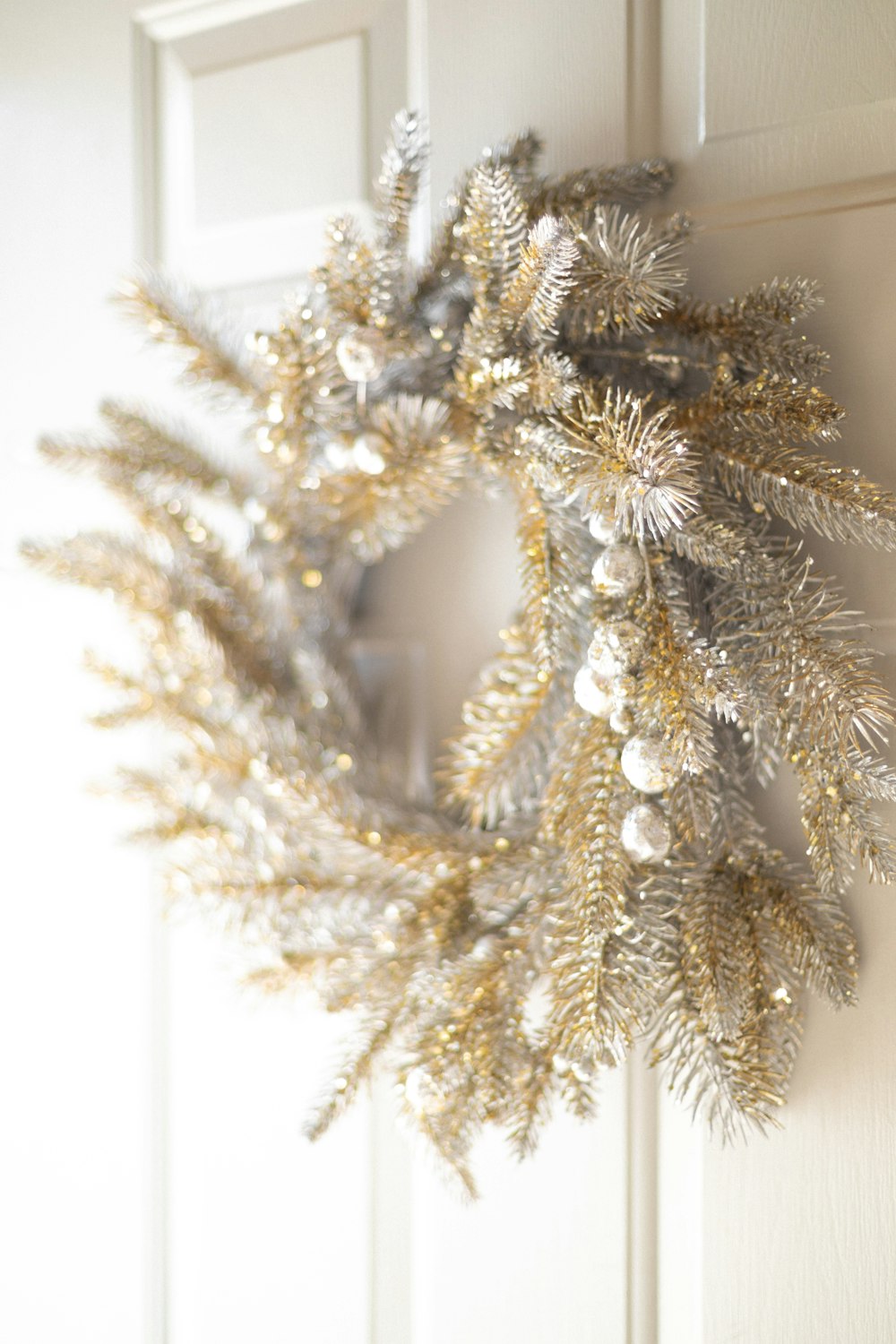 a christmas wreath hanging on a door