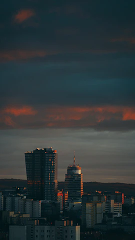 The iconic skyline of Nairobi at dusk, with modern skyscrapers glowing against the evening sky.