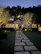 A charming house exterior with warm lights glowing in the evening.