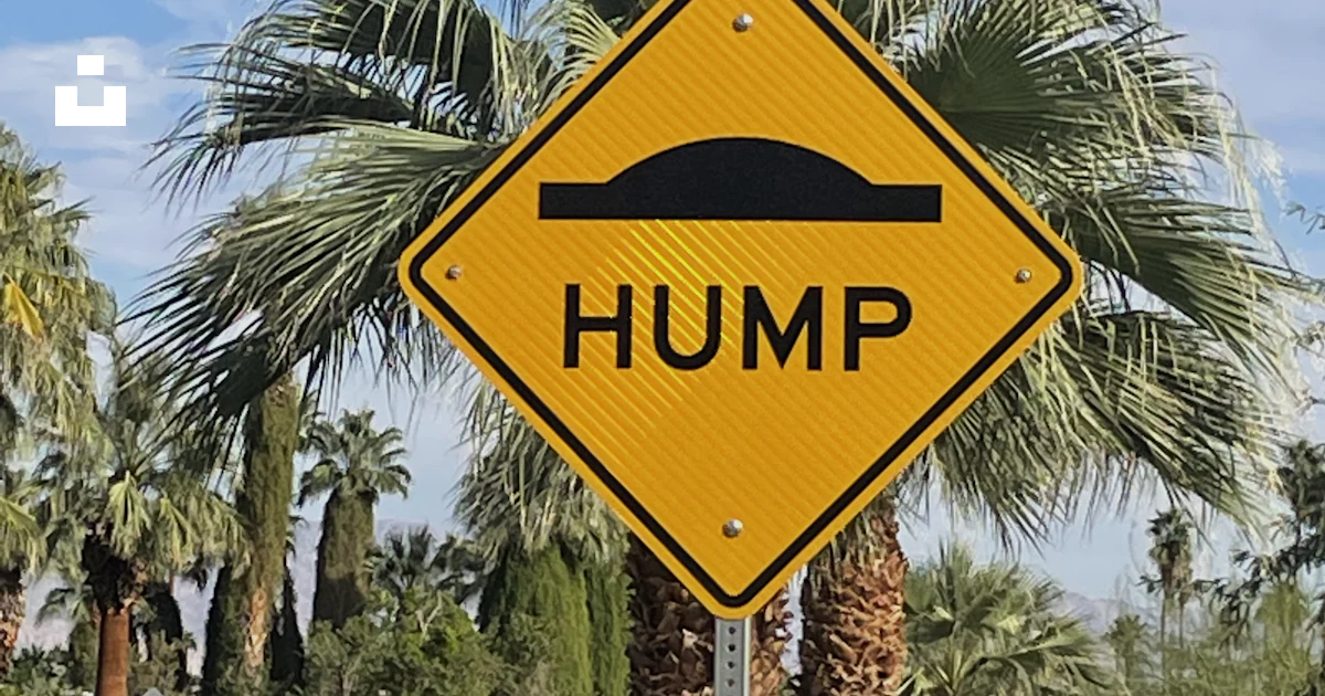 Yellow Rump Sign Road A yellow hump sign sitting on the side of a road photo – Free Street ...