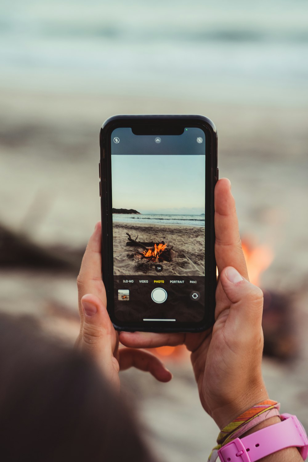 a person holding up a cell phone to take a picture