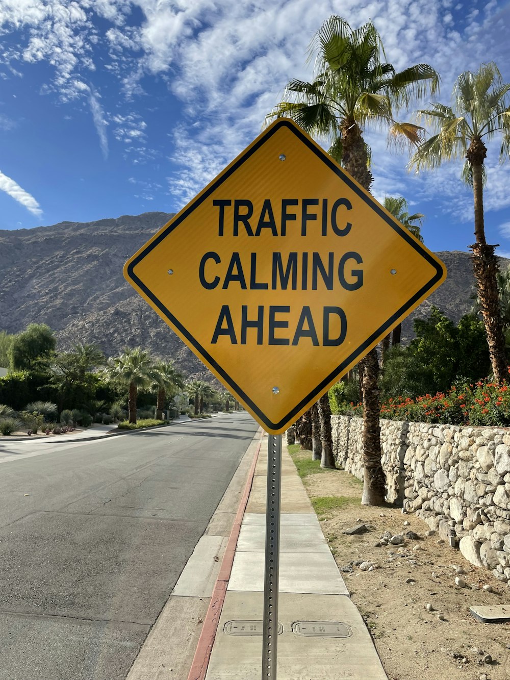 a yellow traffic sign sitting on the side of a road