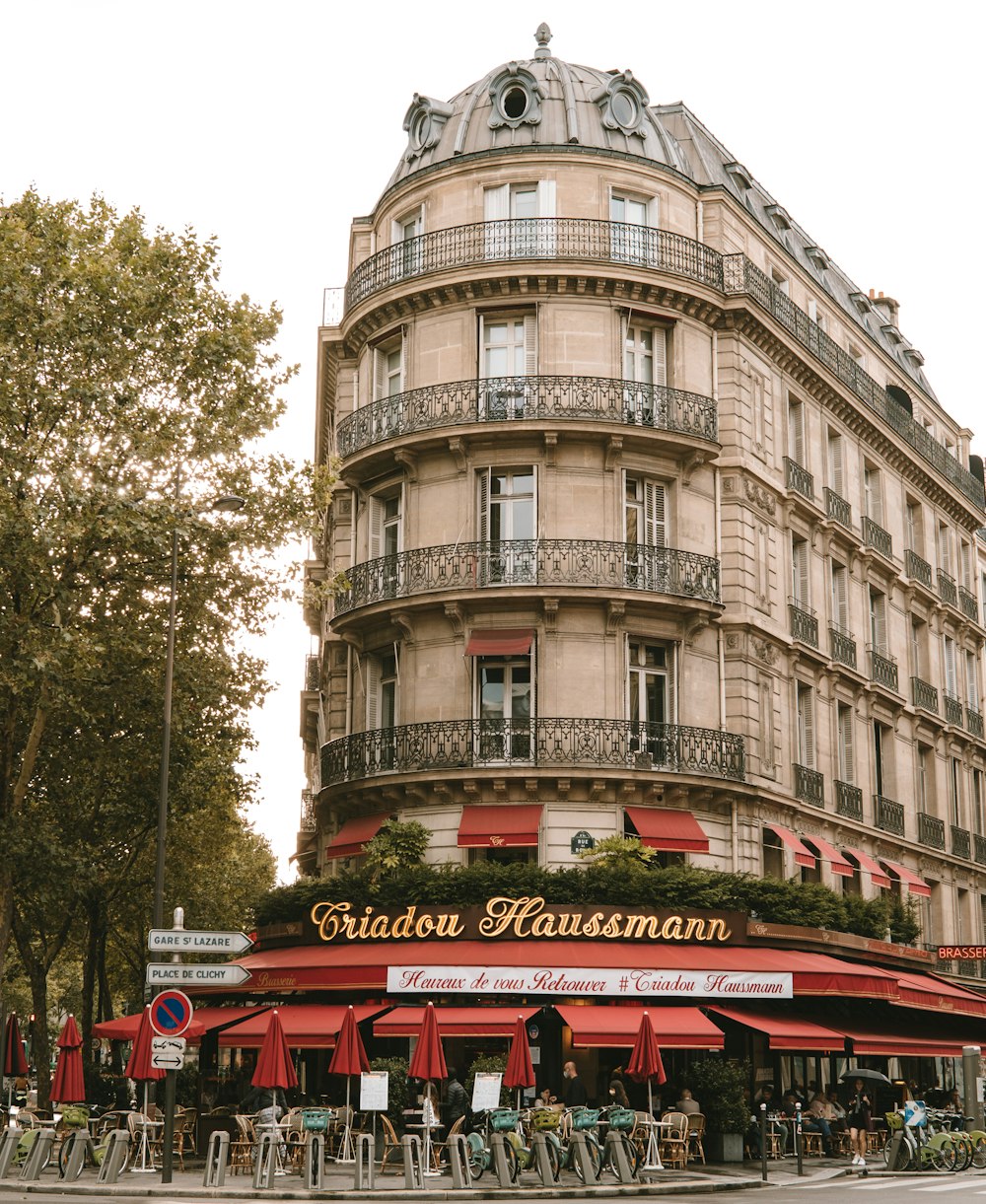 a building with a red awning next to a street