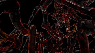 a bunch of red and black chains on a black background