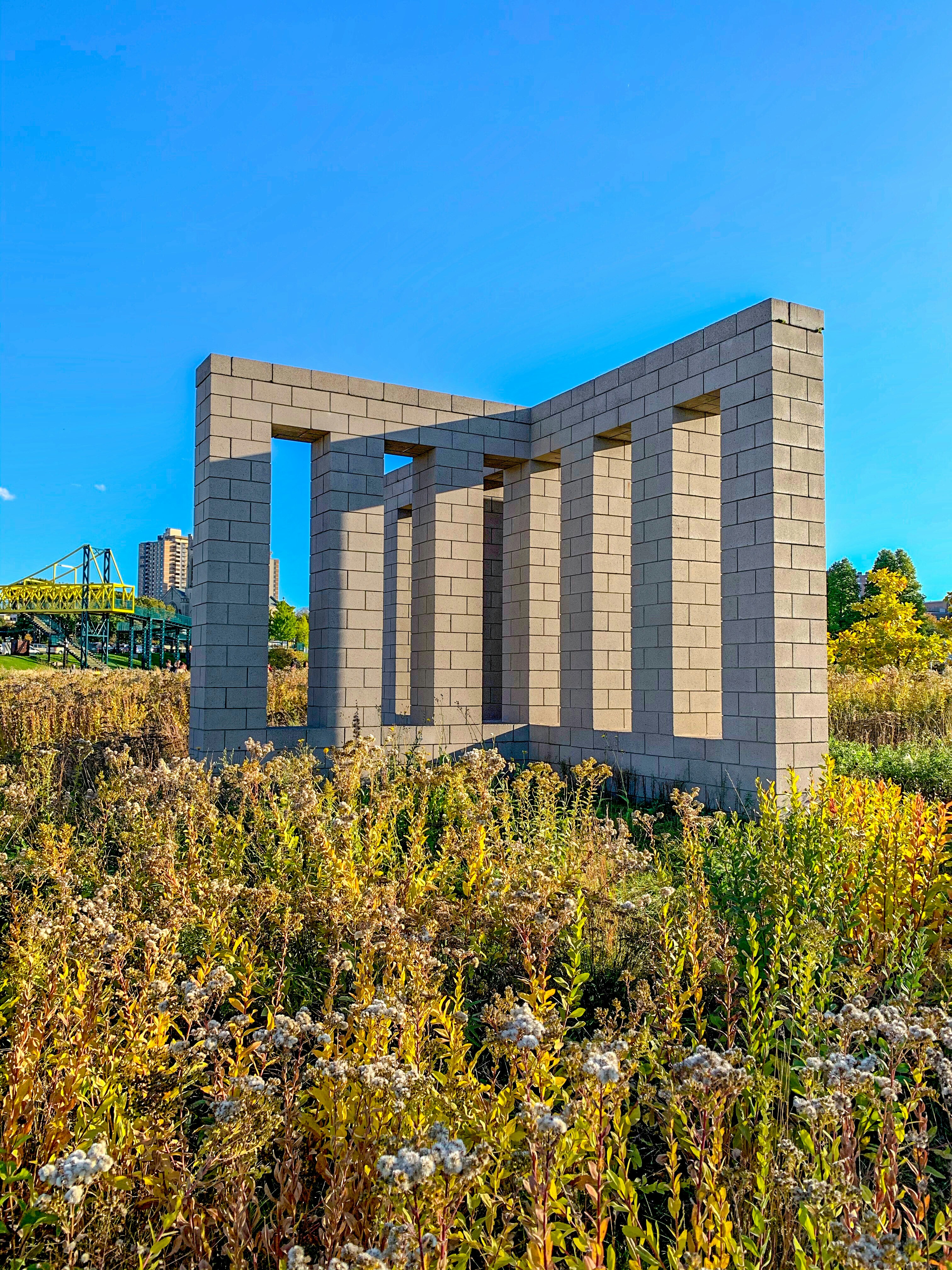 a building made out of cinder blocks in a field