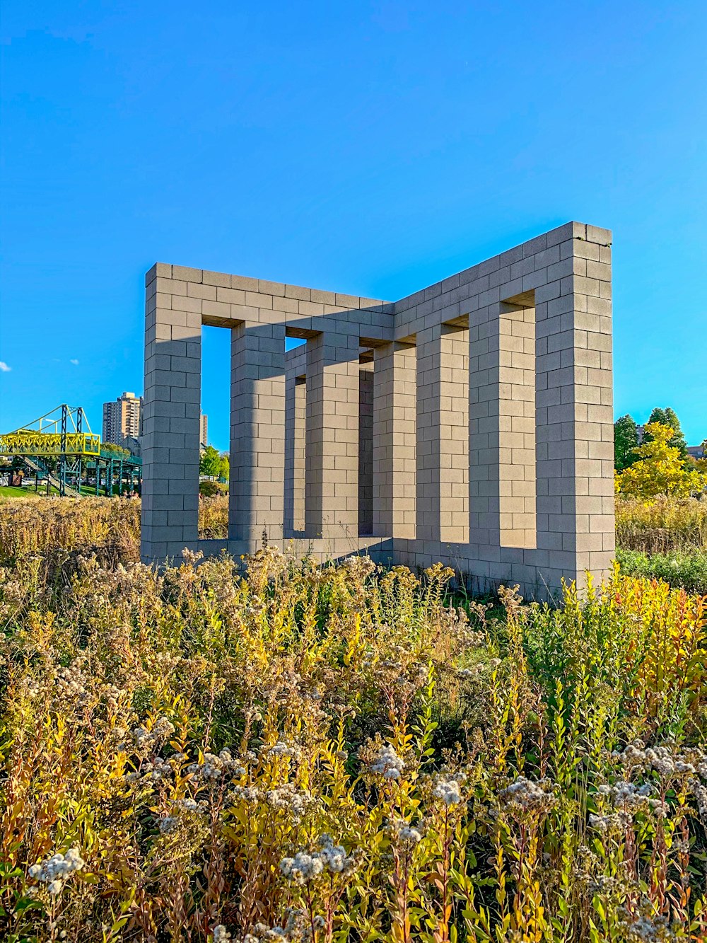 a building made out of cinder blocks in a field