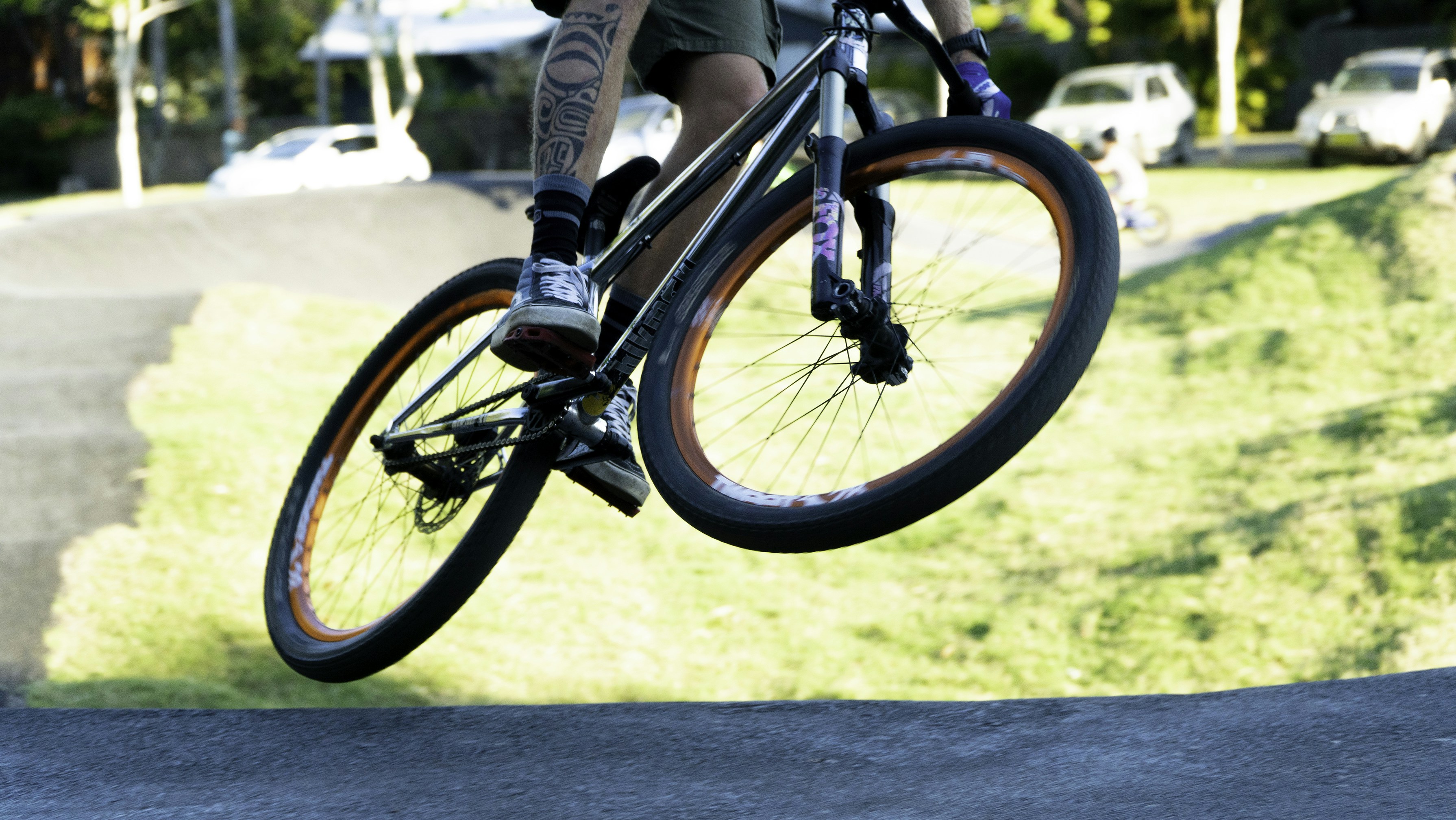 A man riding a bike up the side of a ramp photo – Free Pump track Image ...