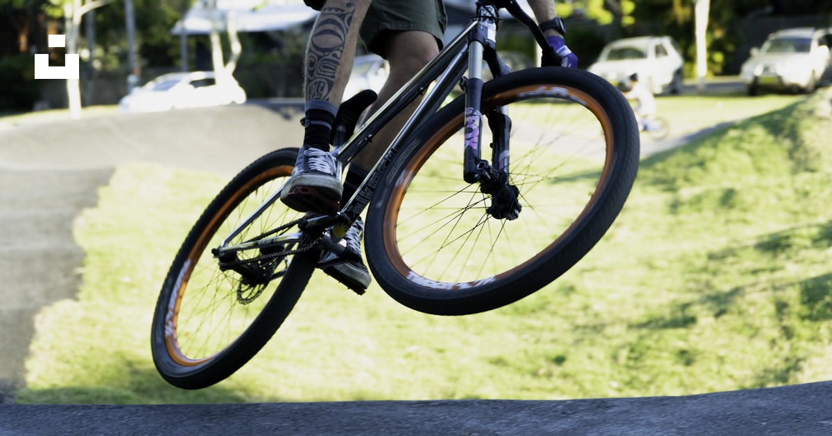 A man riding a bike up the side of a ramp photo – Free Pump track Image ...