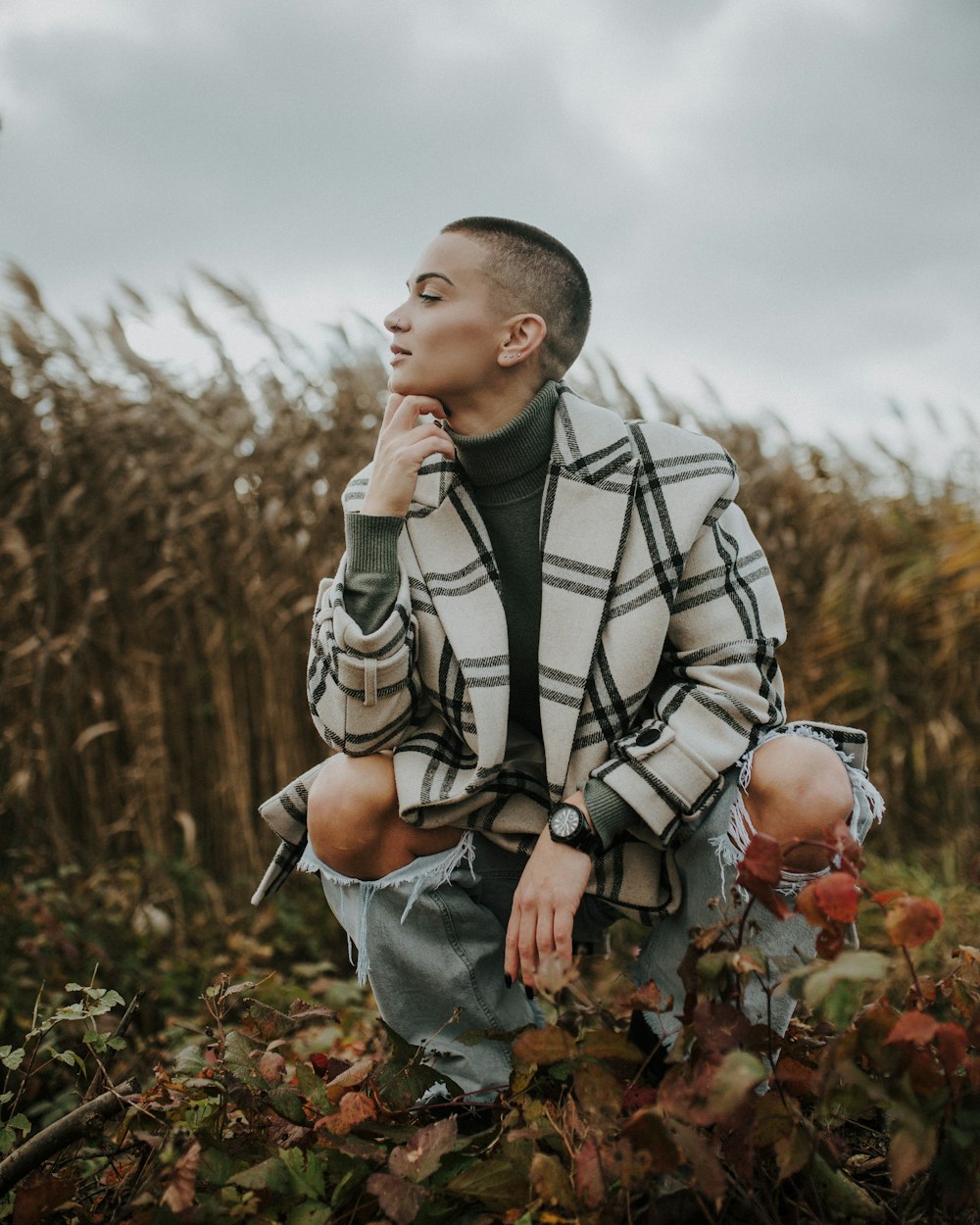 a man sitting in a field of tall grass