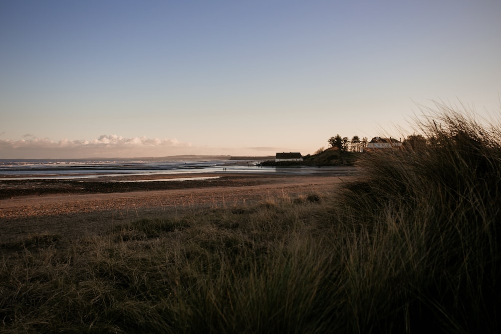 a sandy beach with a house on top of it