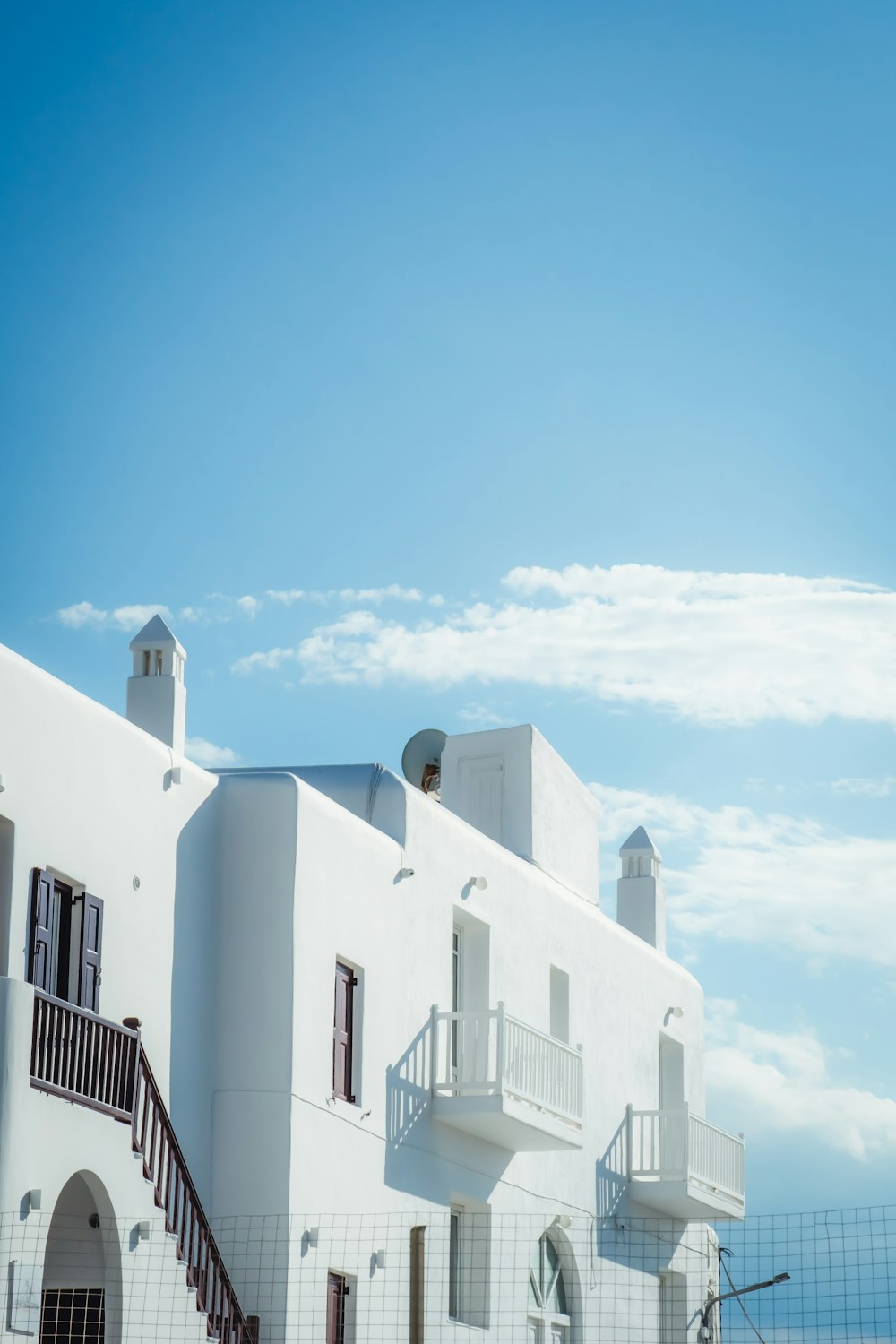 a large white building with a balcony and balconies