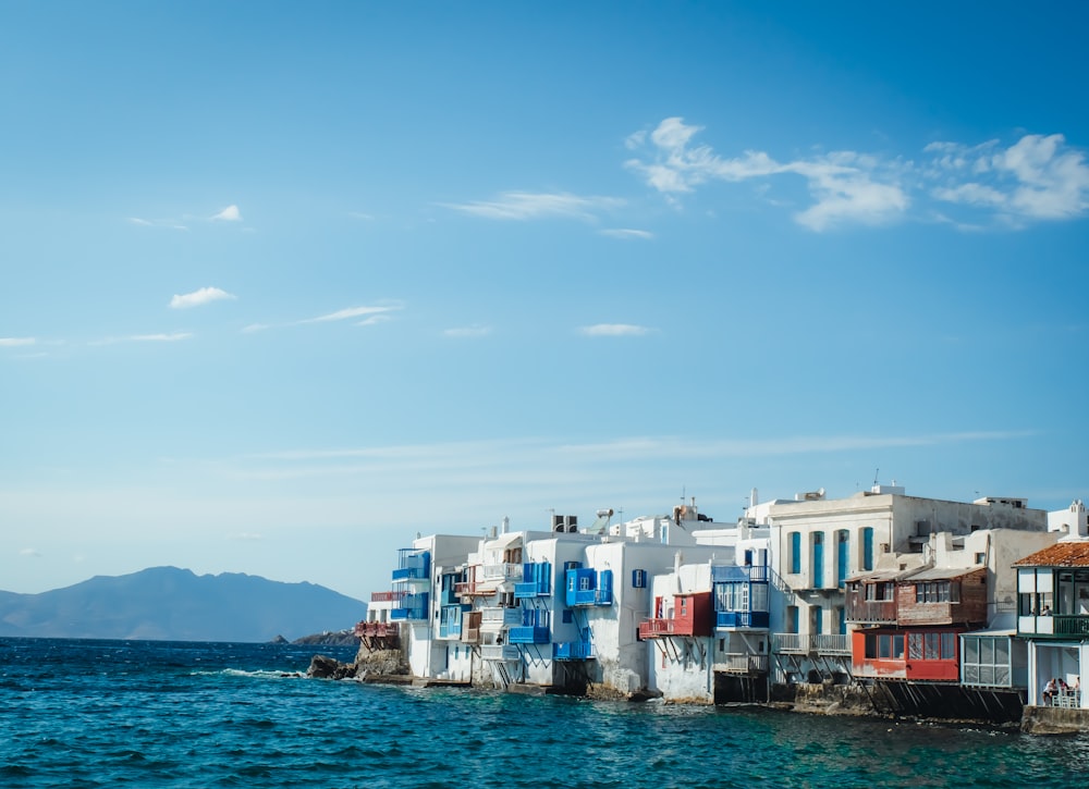 a row of houses on the edge of a body of water