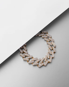 Model wearing the x chain necklace against a crisp white background, highlighting its minimal elegance.