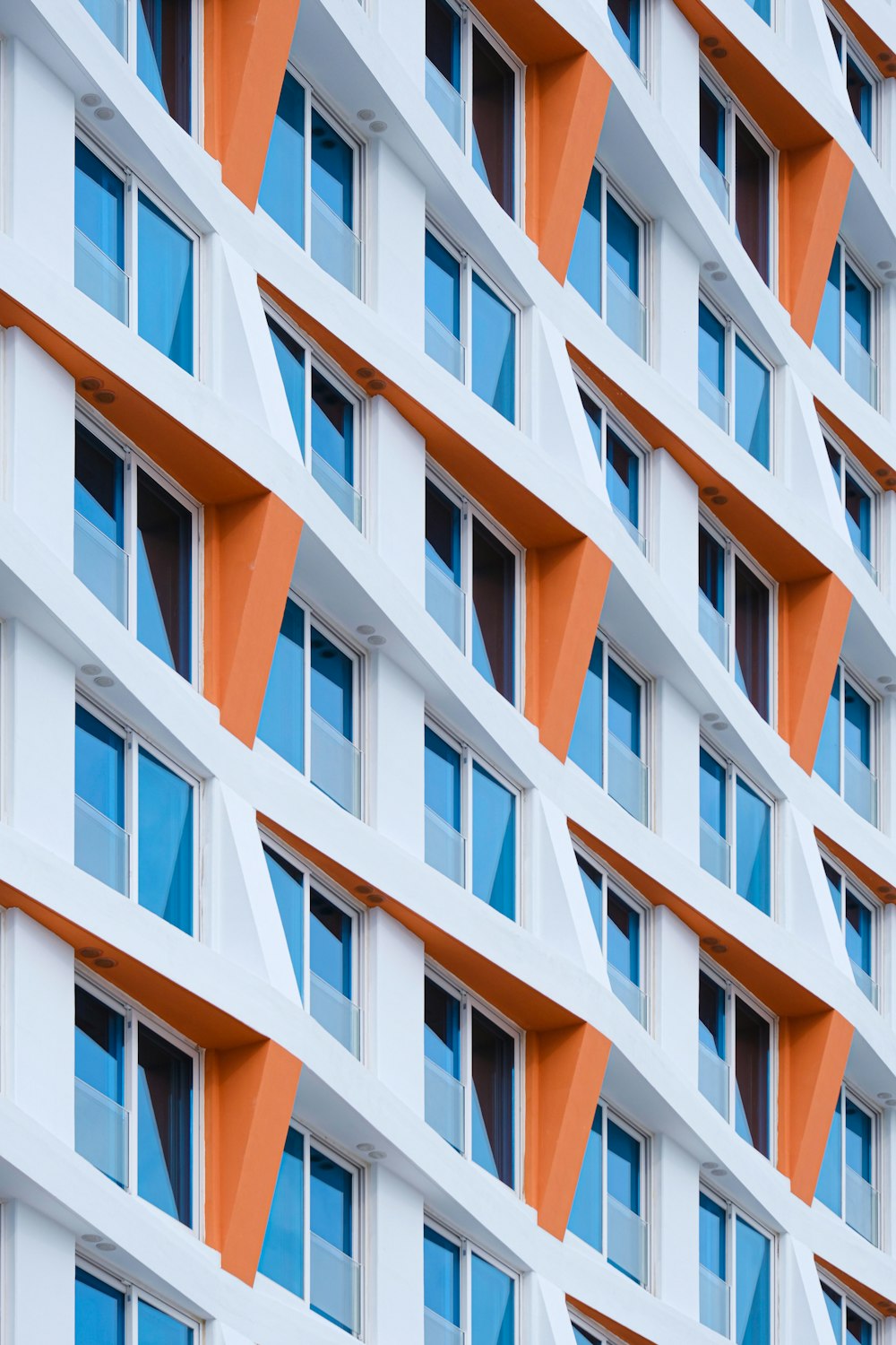 an orange and white building with many windows