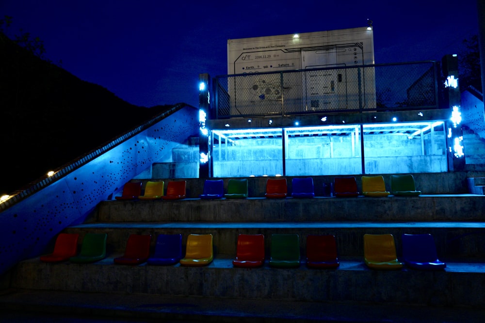 a set of colorful chairs sitting on top of a set of steps