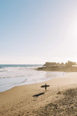 a person holding a surfboard on a beach