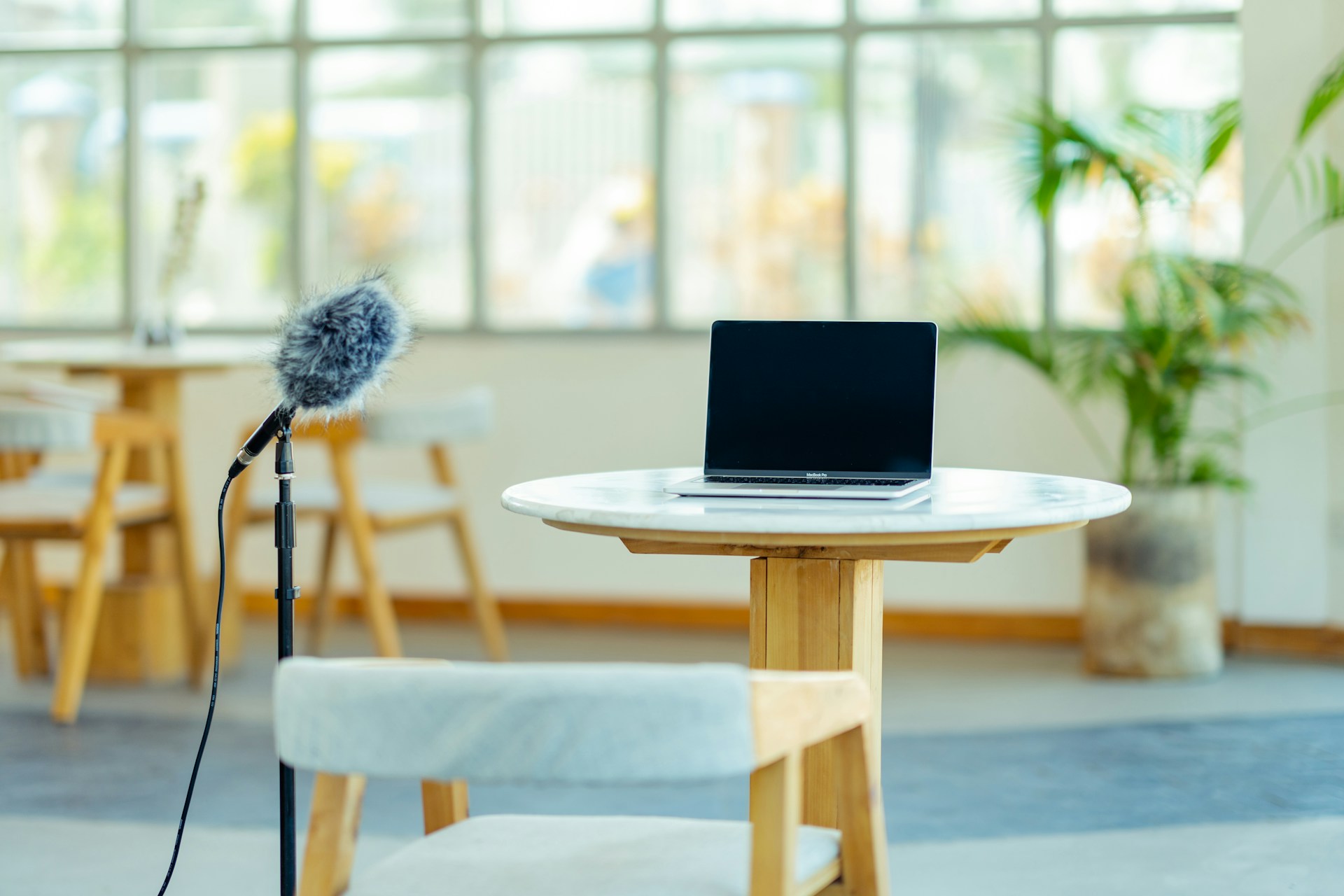 a laptop computer sitting on top of a wooden table