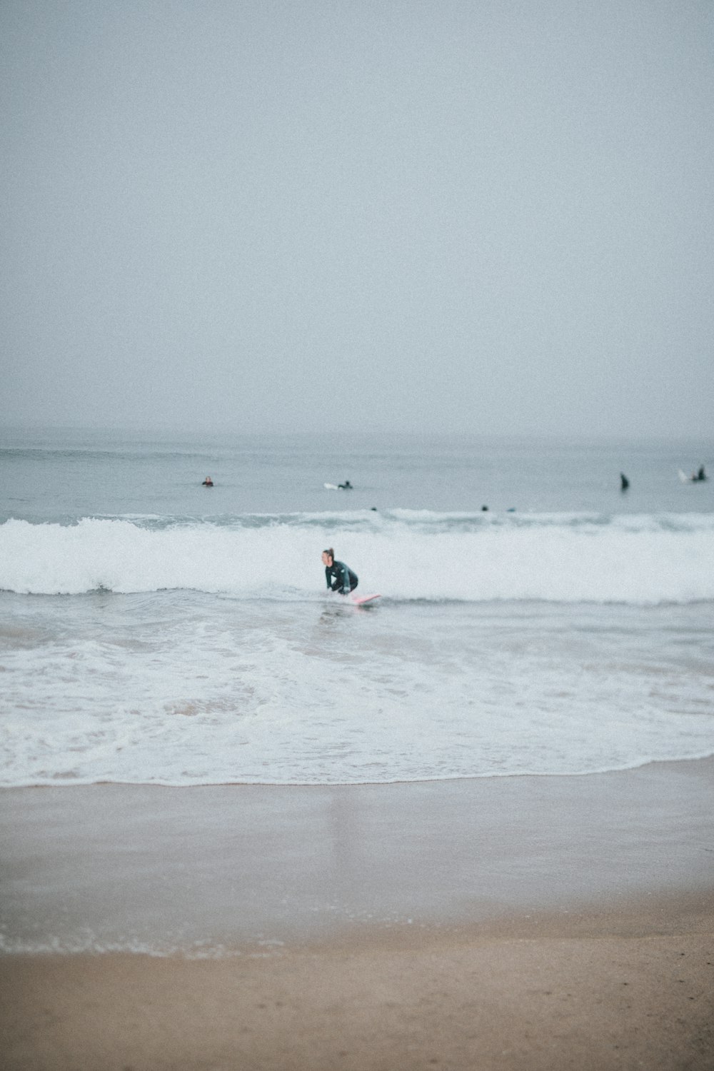 a man riding a surfboard on top of a wave in the ocean