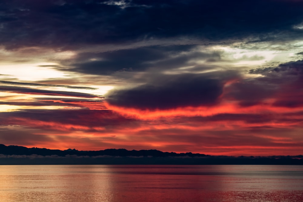 a large body of water under a cloudy sky