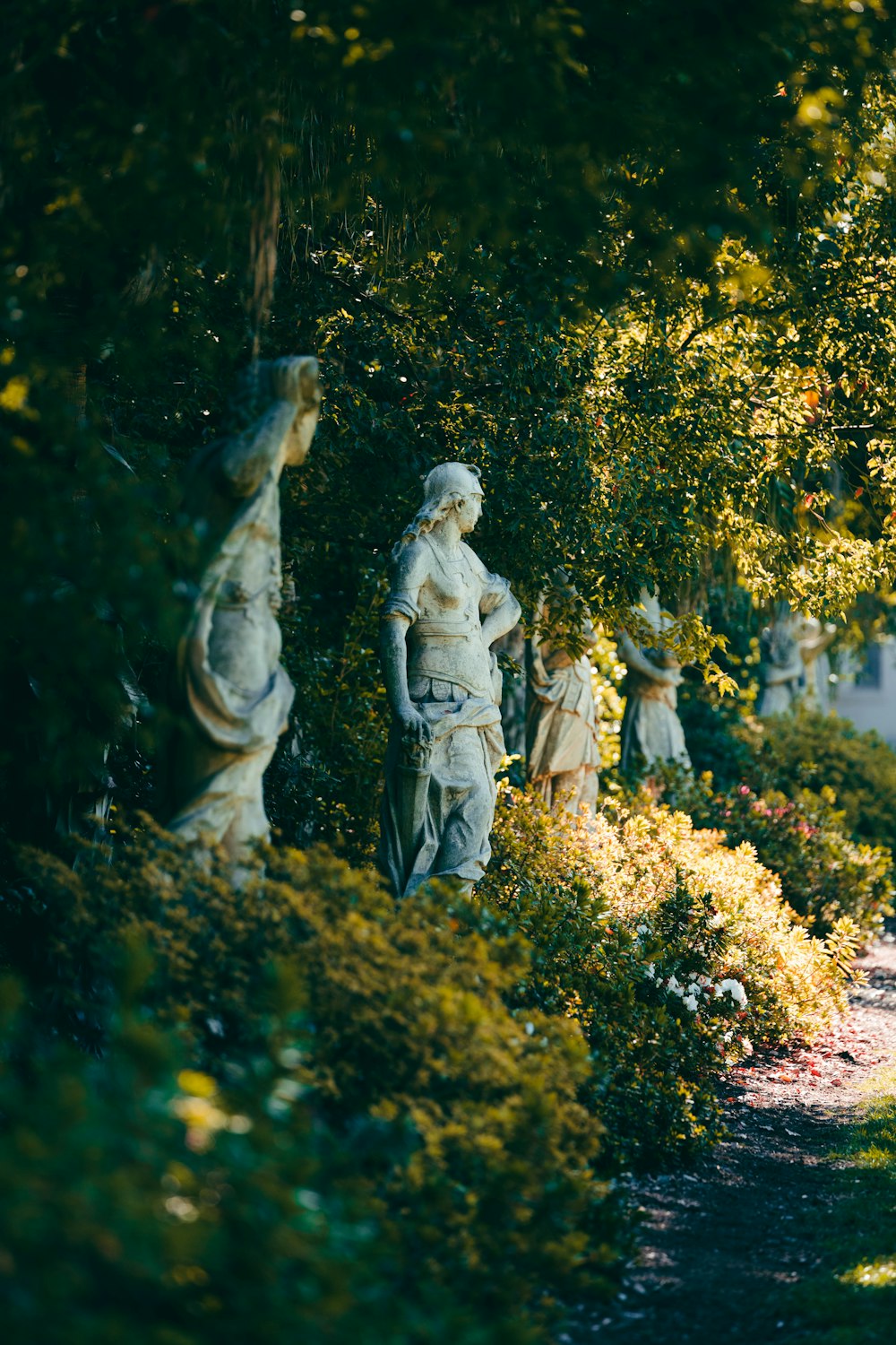 a group of statues sitting on top of a lush green field