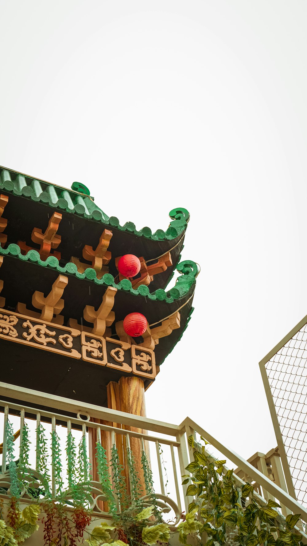 a chinese style building with a green roof