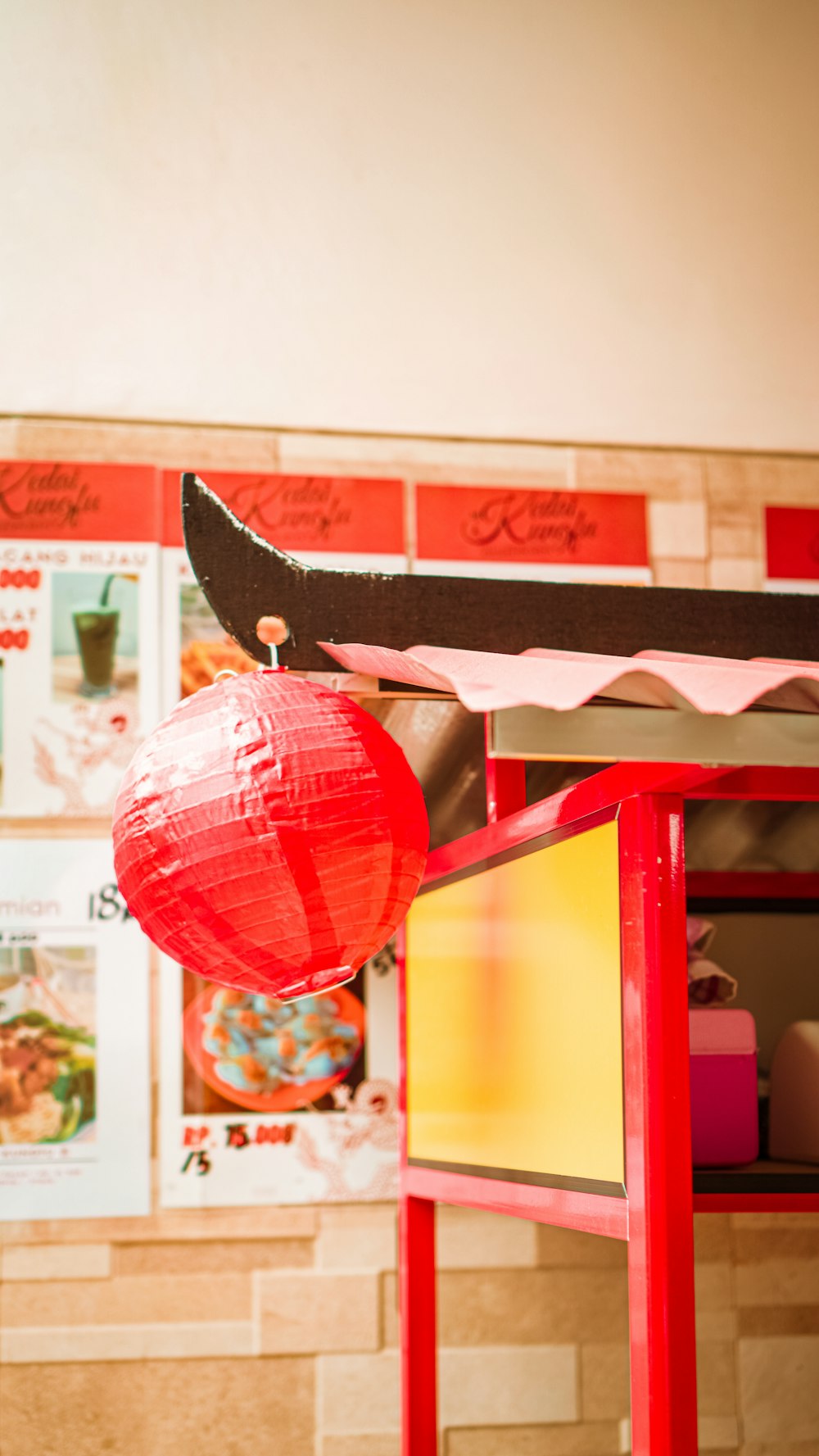 a red table with a red lantern on top of it