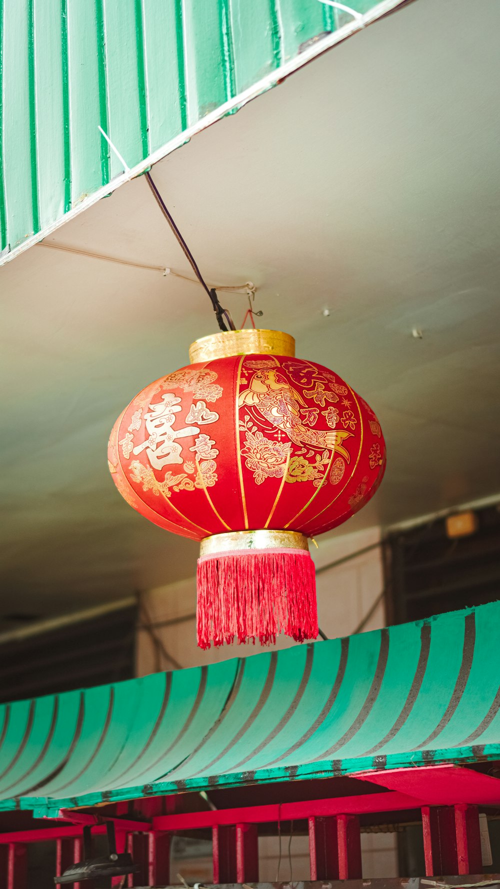 a red chinese lantern hanging from the ceiling