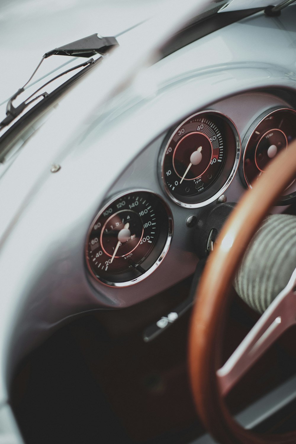 a dashboard of a car with a steering wheel and gauges