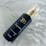 A luxurious hair serum bottle with a gold aesthetic on a marble background.