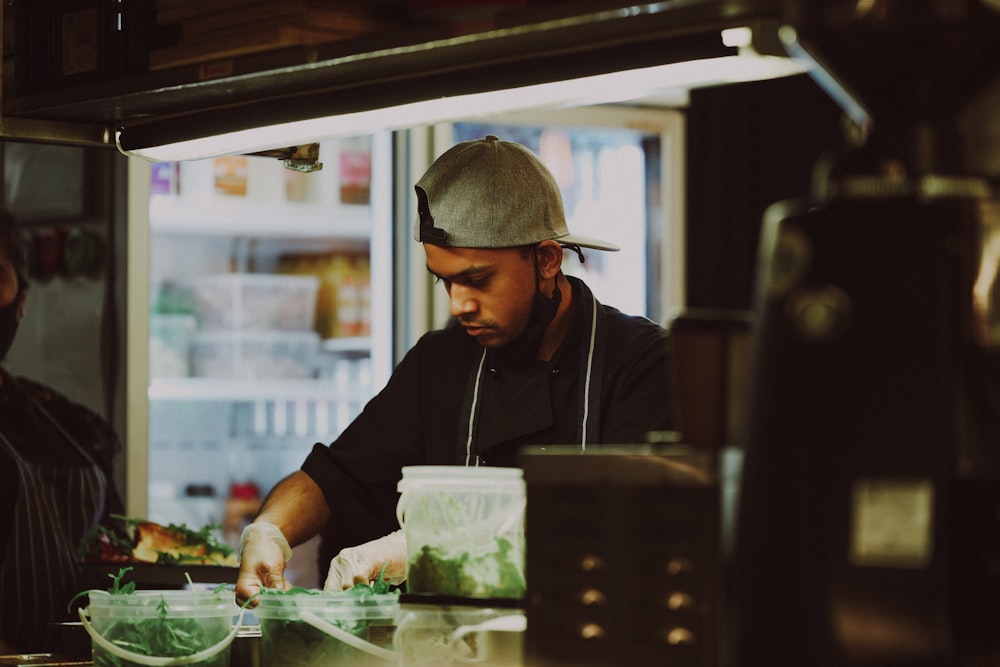 a man and woman preparing food in a restaurant