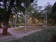 A well-maintained garden area with walking paths and ambient lighting, perfect for evening strolls.